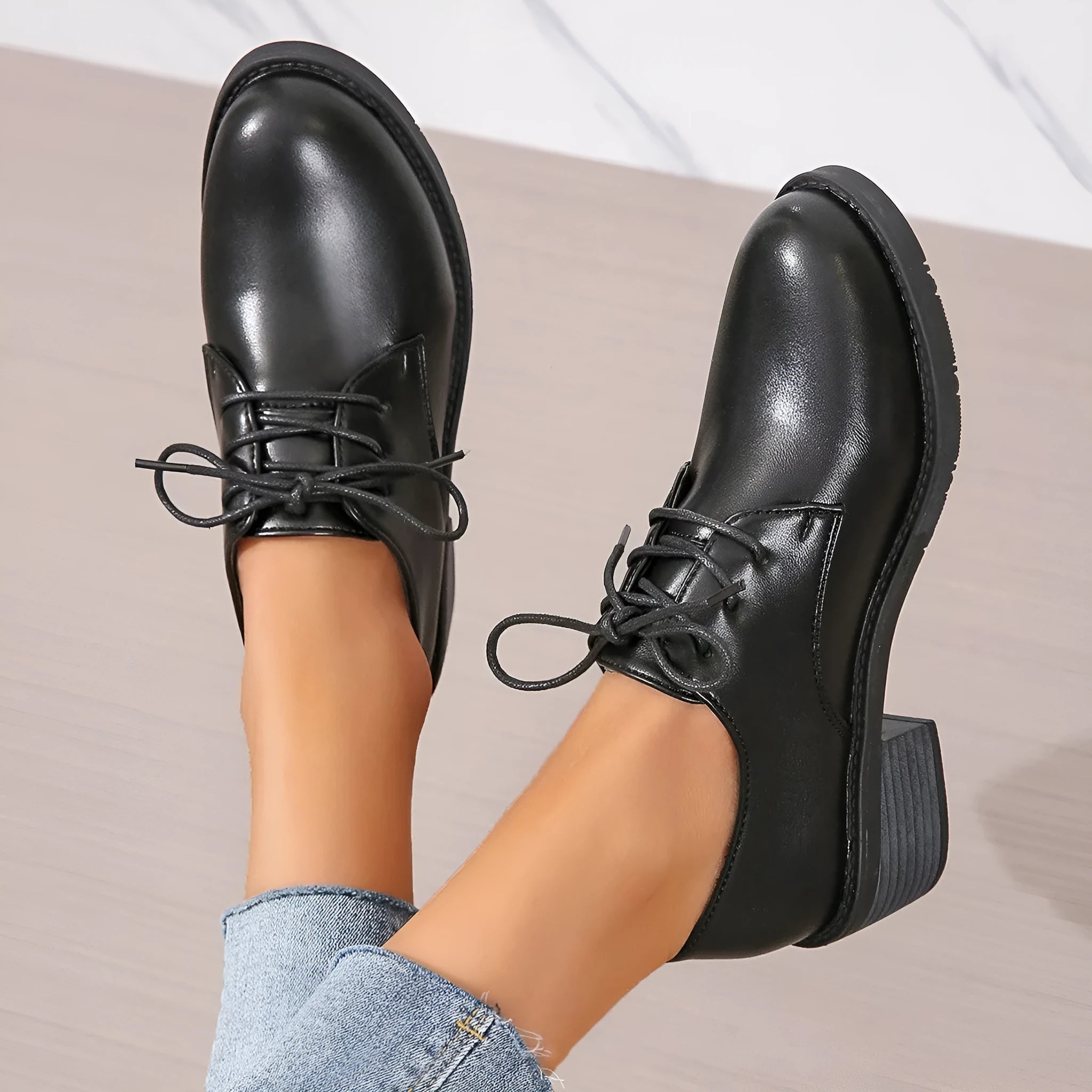 Black women's low-top shoes with a thick chunky heel and rubber sole.