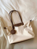 Beige Oxford cloth tote bag with sandwich pocket design and shoulder strap