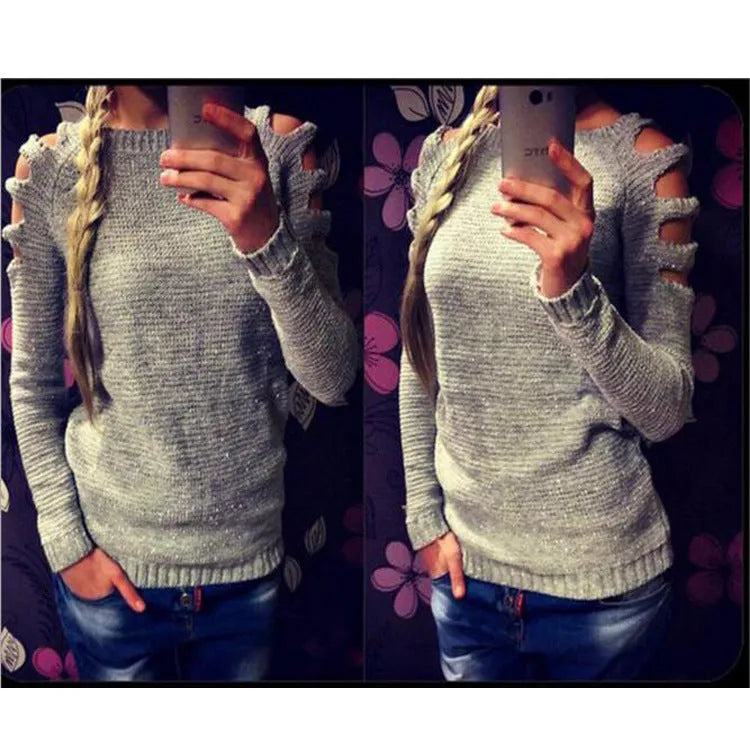 Women's grey hollow-out crochet knitted long sleeve shirt with round neck on a hanger.