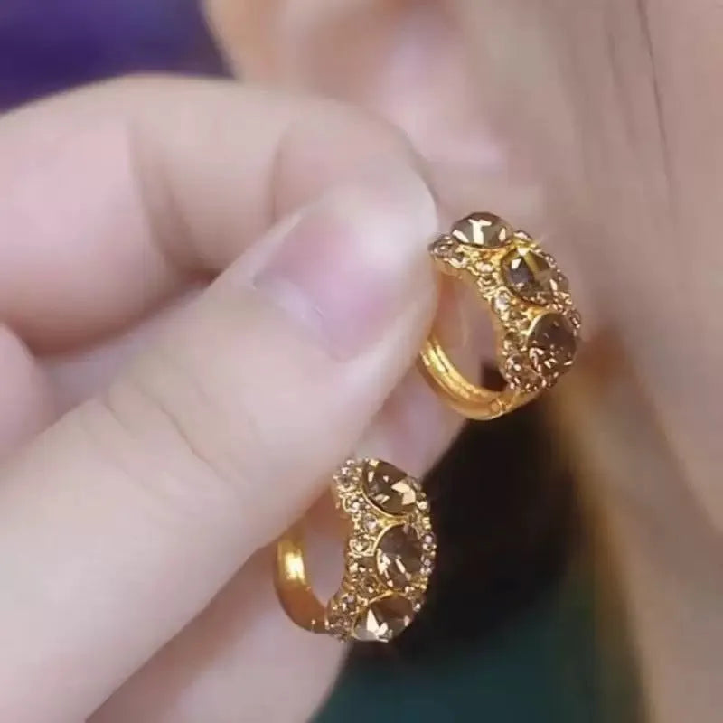 Gold metal hoop earrings with diamond surface treatment and brown zircon stones