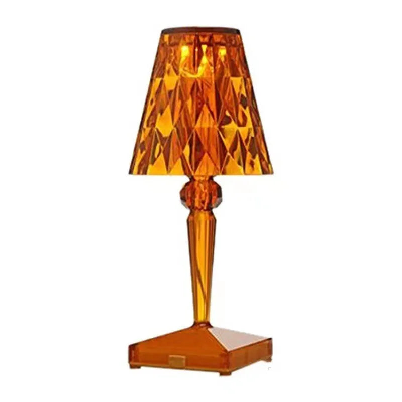 Rose gold portable touch control night light on a table.