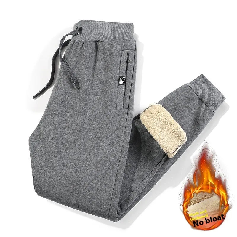 Men's grey fleece-lined oversized track pants with elastic waistband and straight leg design