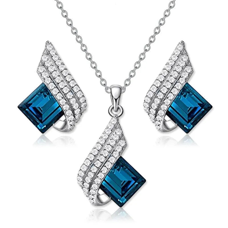 Women's jewellery set showing necklace with cross chain and matching earrings with glass elements