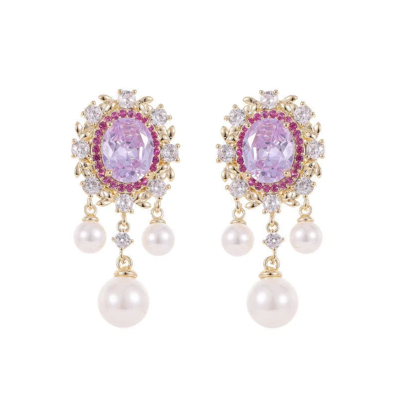 Oval-shaped copper drop earrings with inlaid zircon stones, white pearls, and a light purple tassel.