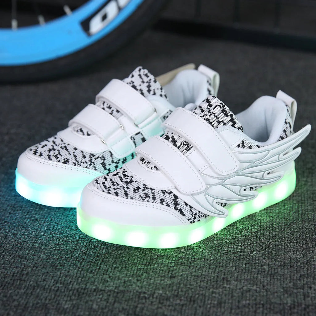 Plum red children's LED light-up sneakers on a white background, showing USB charging port.