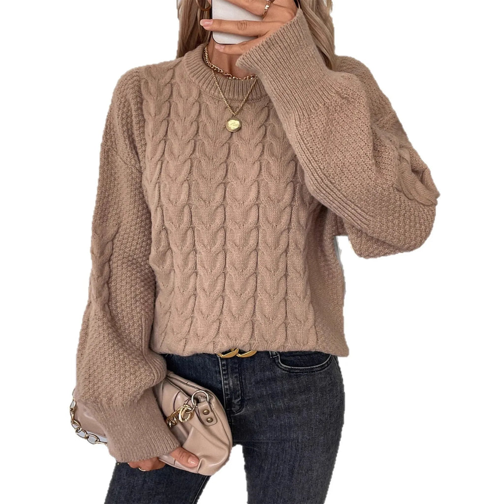 Women's loose beige round neck pullover sweater on a hanger.