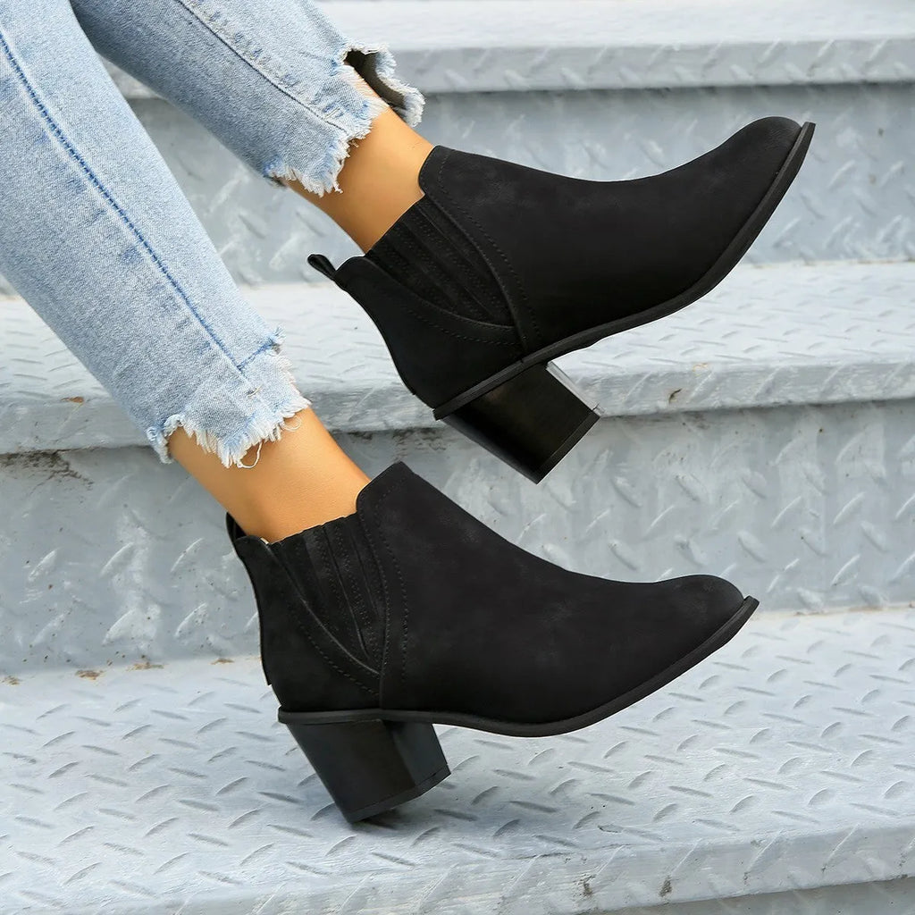 Women's black and brown pointed toe ankle boots with thick square heel and slip-on design made of artificial PU.