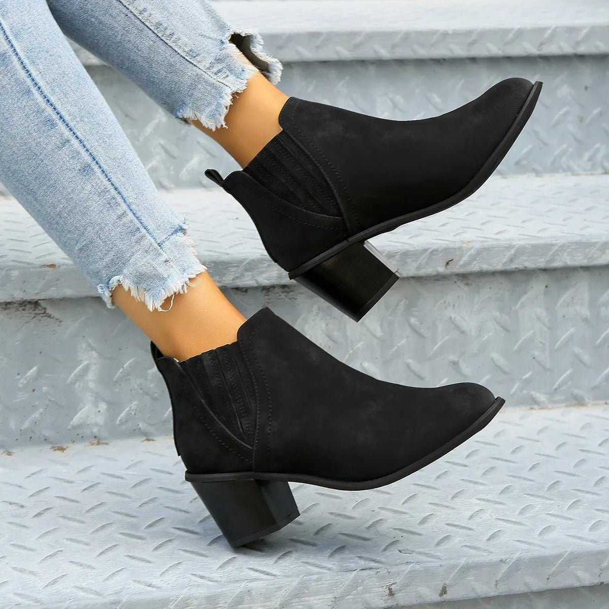 Women's black and brown pointed toe ankle boots with thick square heel and slip-on design made of artificial PU.