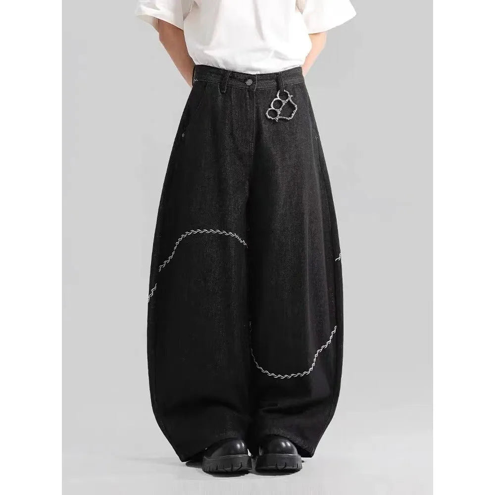 Black straight-leg men's trousers with a mid-waist and zip fly on a hanger.