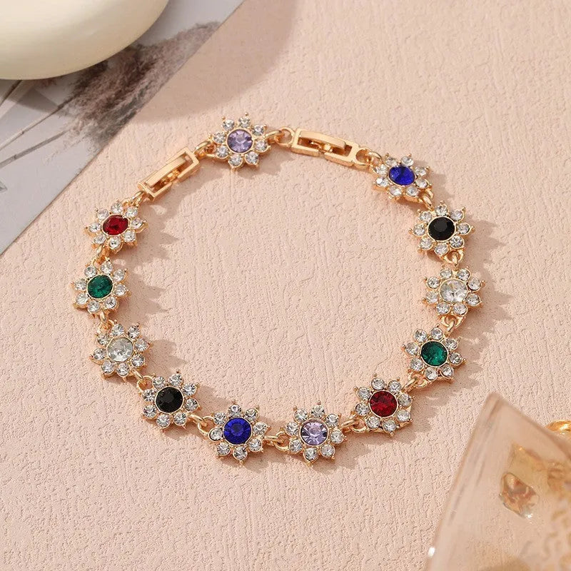 Electroplated zinc alloy flower bracelet with coloured gems in gold and silver colour options
