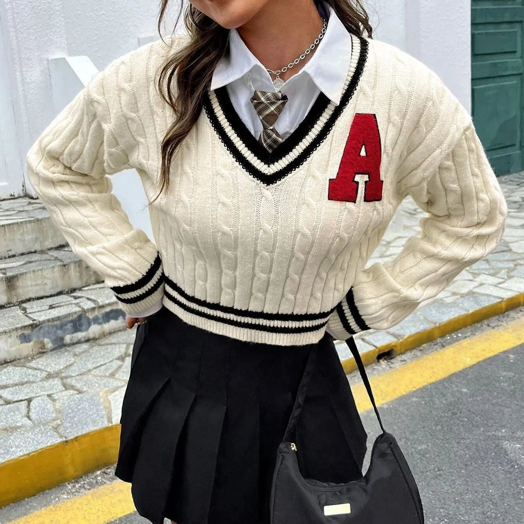 V-neck creamy white knitted shirt with slim stripes and patch detail on model