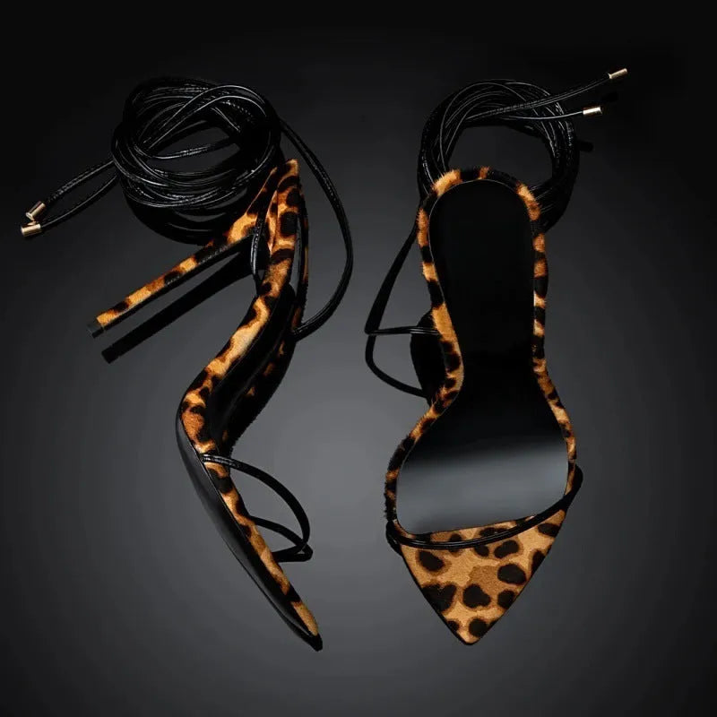 Women's leopard print Roman sandals with pointed toes and a buckle lace-up strap.