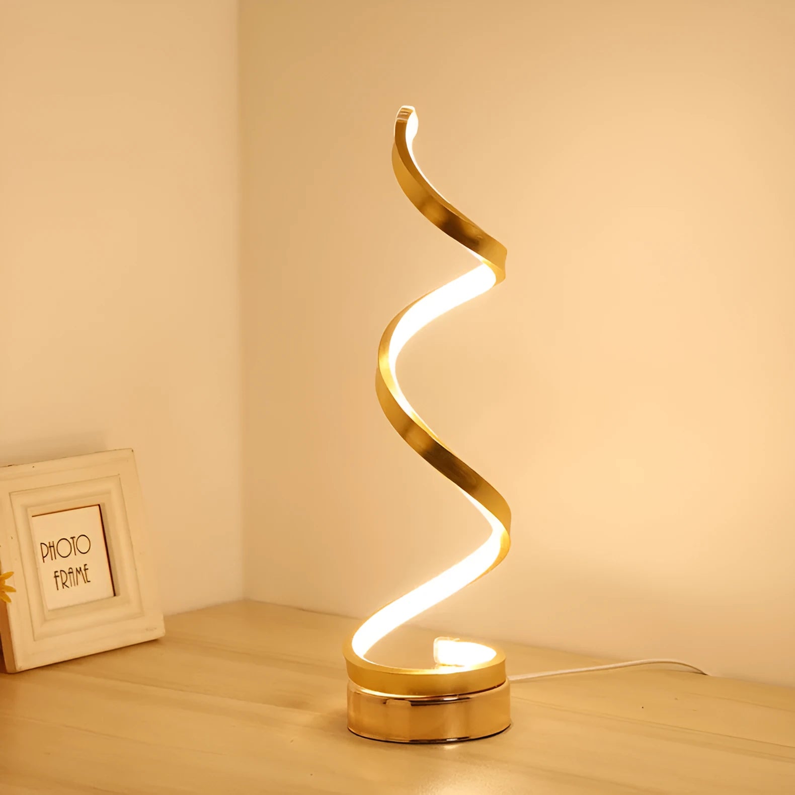 Black minimalist LED bedside table lamp with aluminium shade and metal base on wooden table