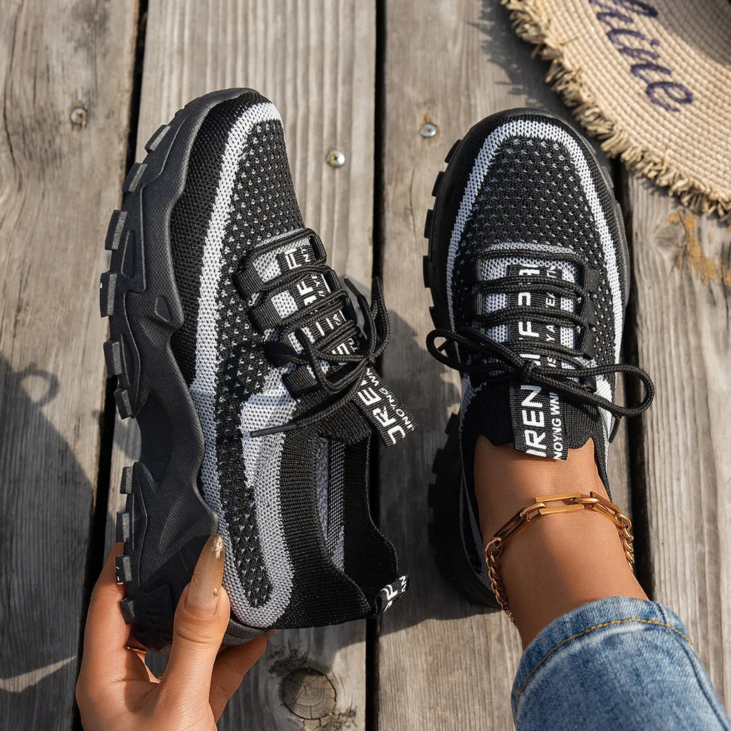 Women's Flyknit mesh lace-up sneakers in various colours on a flat rubber sole.