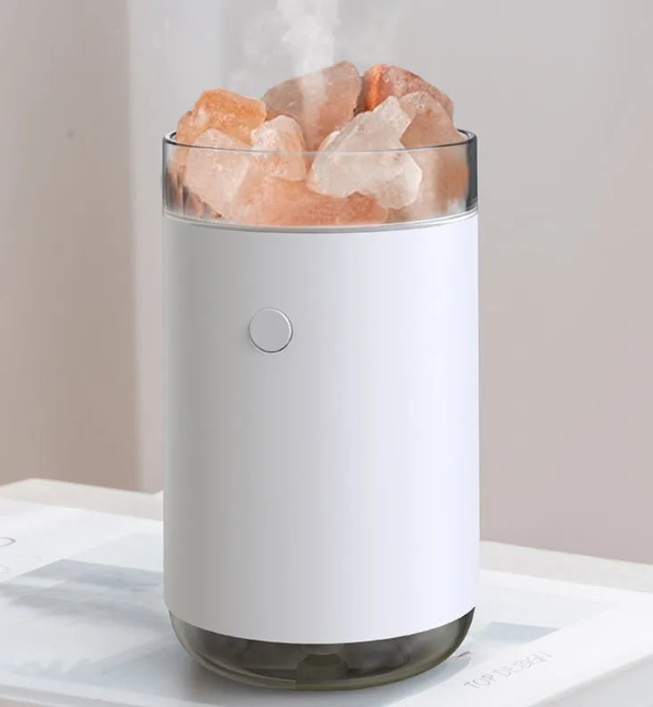 Ultrasonic aromatherapy diffuser humidifier with natural crystal salt stone and LED lamp in blue, showing mist and light