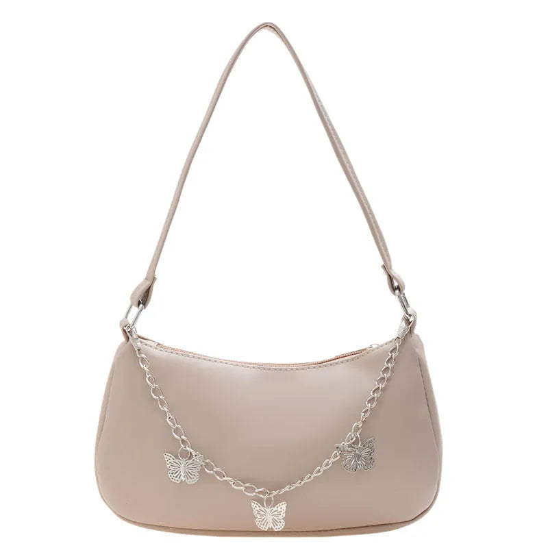 Women's black PU leather butterfly chain crossbody bag with convertible strap showing internal organisation compartments