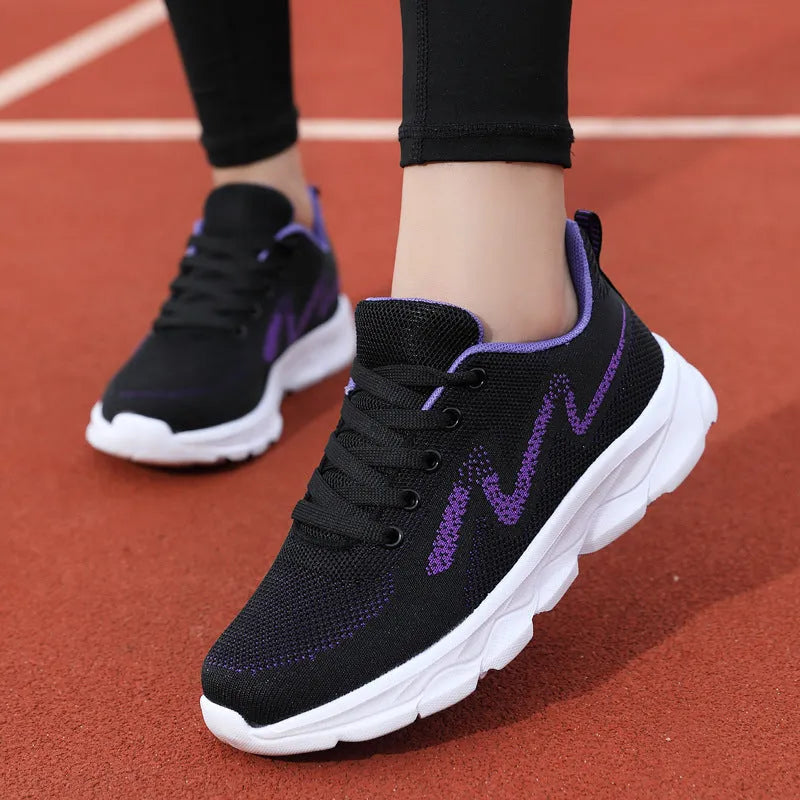 Women's lightweight mesh breathable running shoes with wedge heel in black upper side view