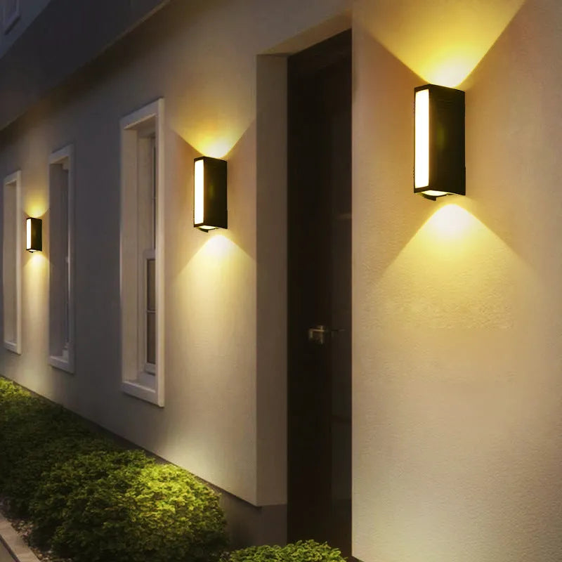 Simple modern outdoor waterproof LED wall lamp in black aluminium with glass panel for garden or patio