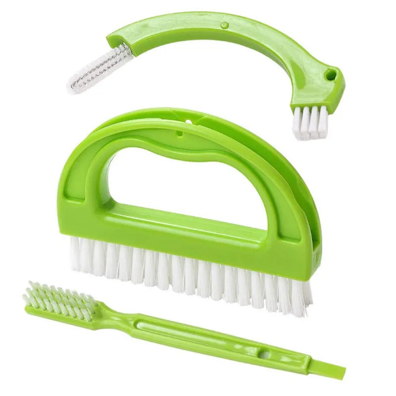 Three green plastic floor seam cleaning brushes arranged on a hard floor surface