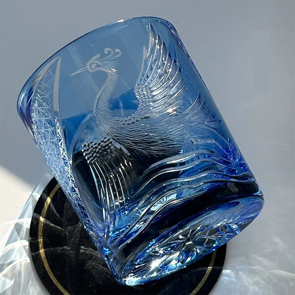 Hand-carved sky blue crystal whiskey shot glass on a wooden surface, 90x100mm size