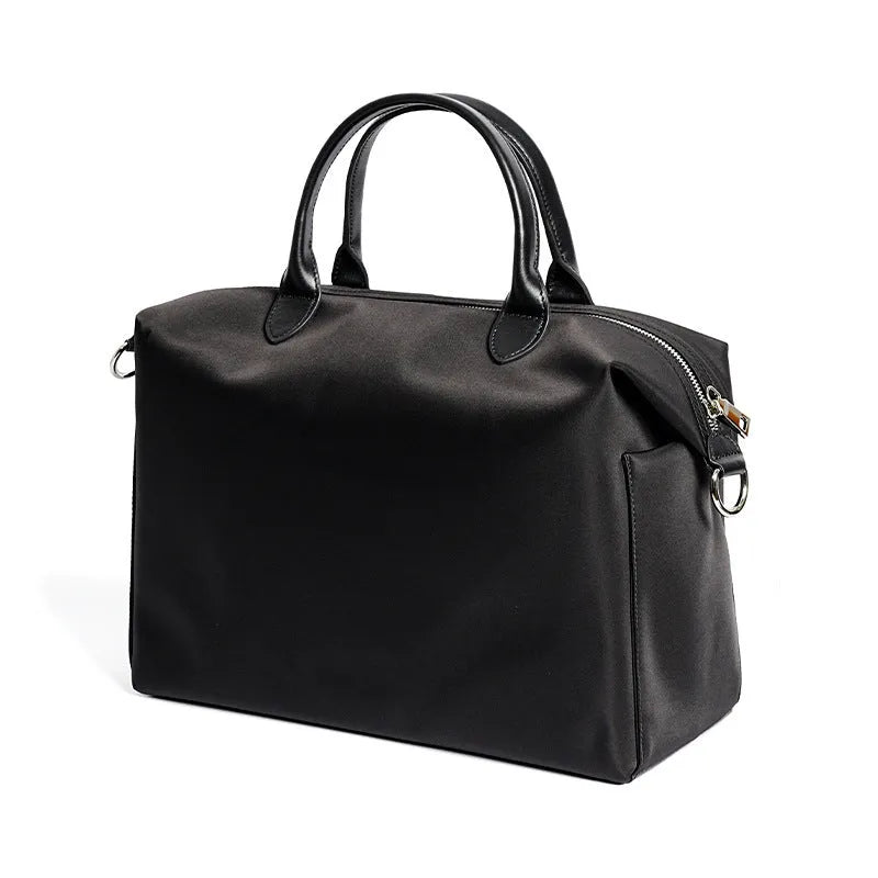 Nylon waterproof shoulder bag in black or light khaki measuring 35cm wide with leather accents