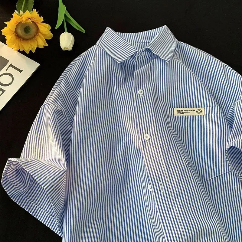 Blue striped plus size loose half sleeve shirt on hanger