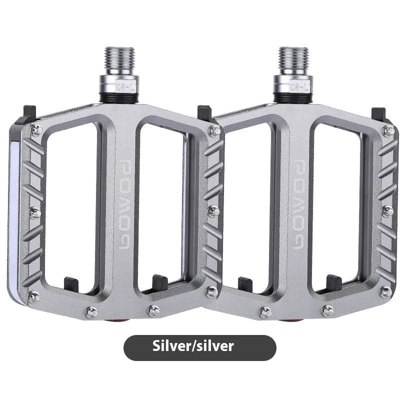 Pair of aluminium alloy bicycle pedals with integrated LED lights in multiple colour options.