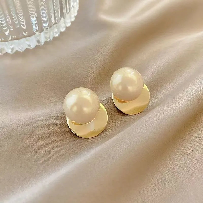 Alloy round stud earrings for women, casual style with metal finish, side view on model