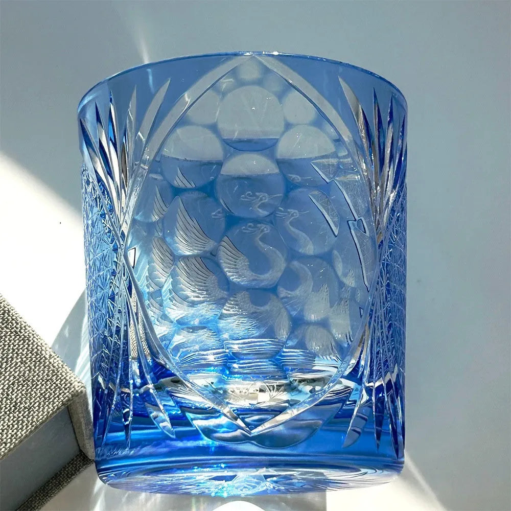 Hand-carved sky blue crystal whiskey shot glass on a wooden surface, 90x100mm size