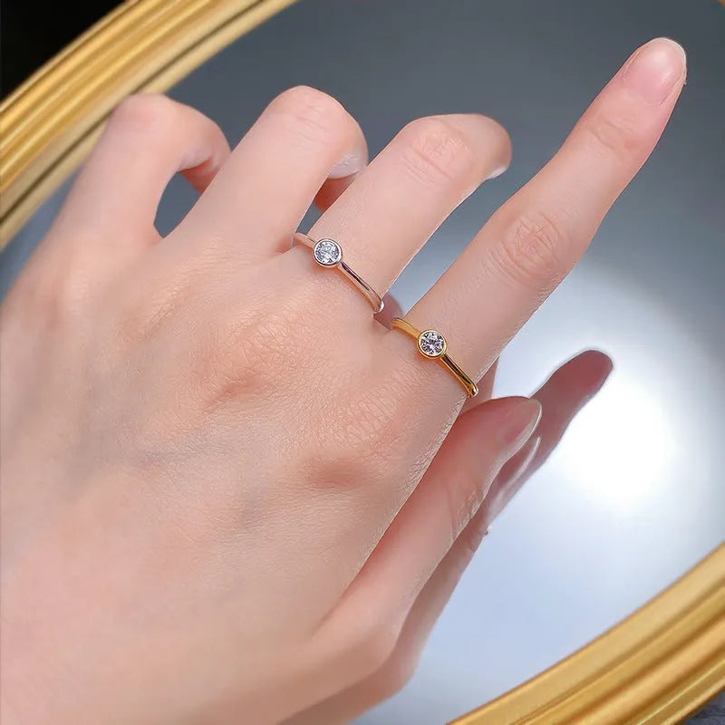 Minimalist silver crown-shaped ring with linear design, shown in electroplated gold and platinum finishes.