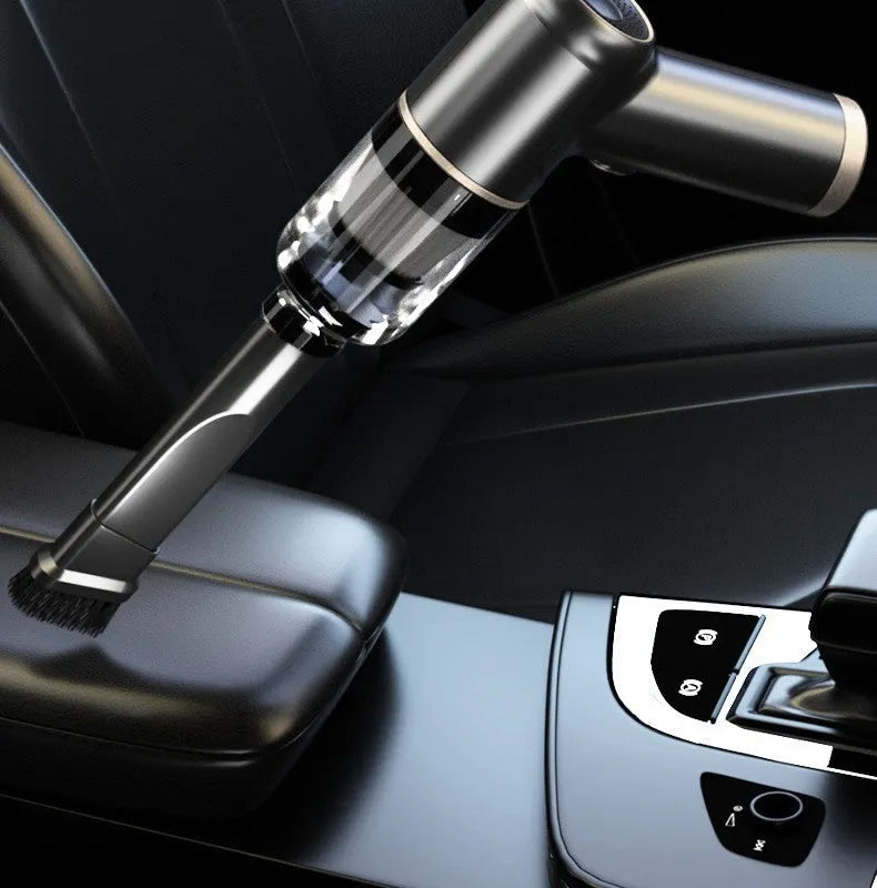 Black cordless handheld car vacuum cleaner with attachments including brush head and inflation nozzles.