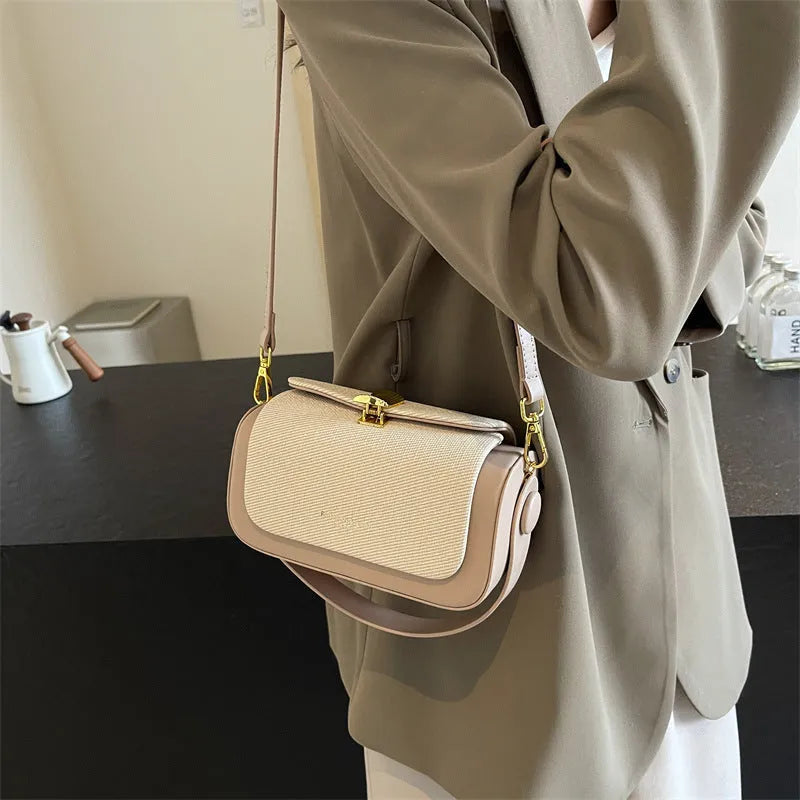 Women's black PU leather messenger bag with contrast stitching and a lock detail.