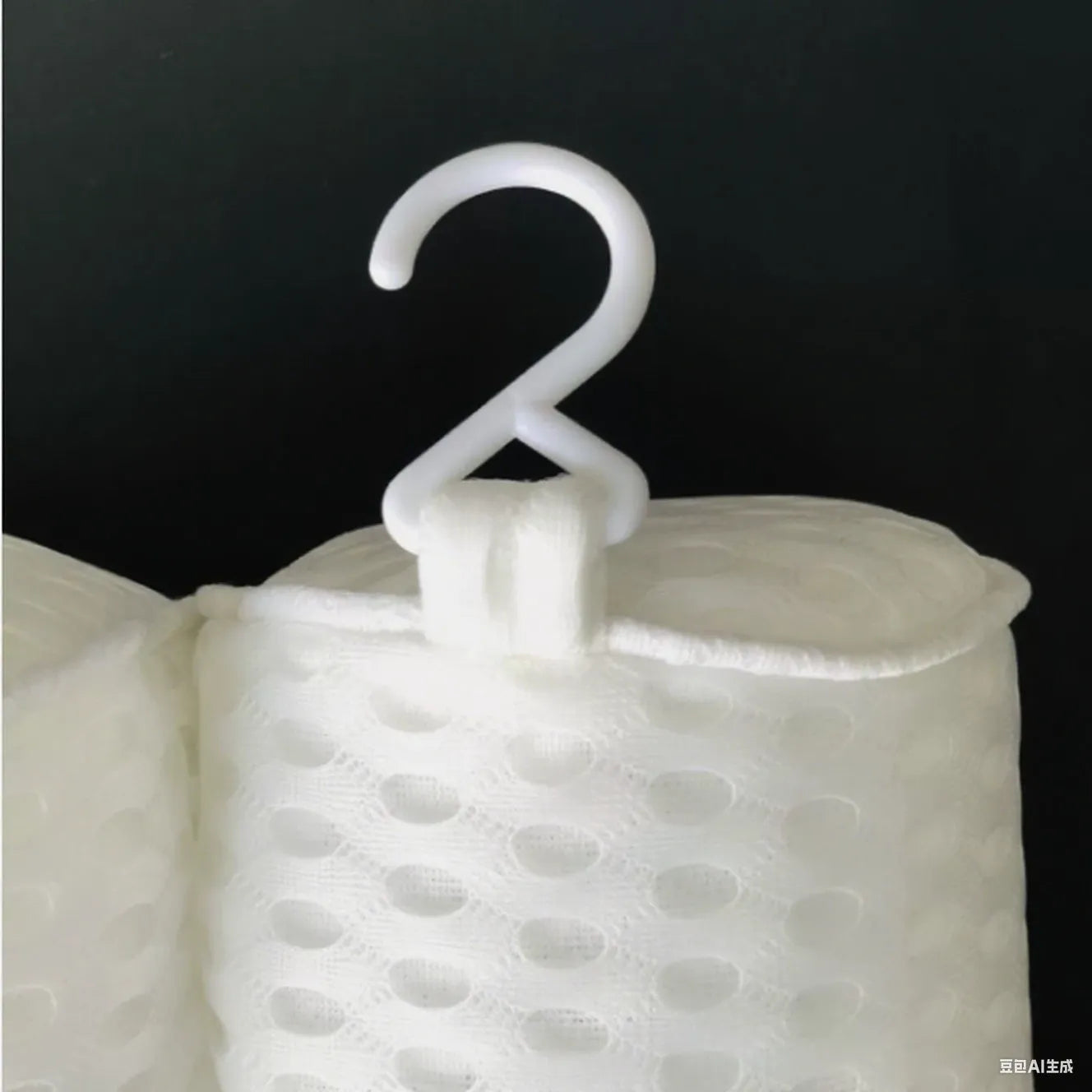 White 4D mesh bathtub pillow with suction cups on a bathtub.