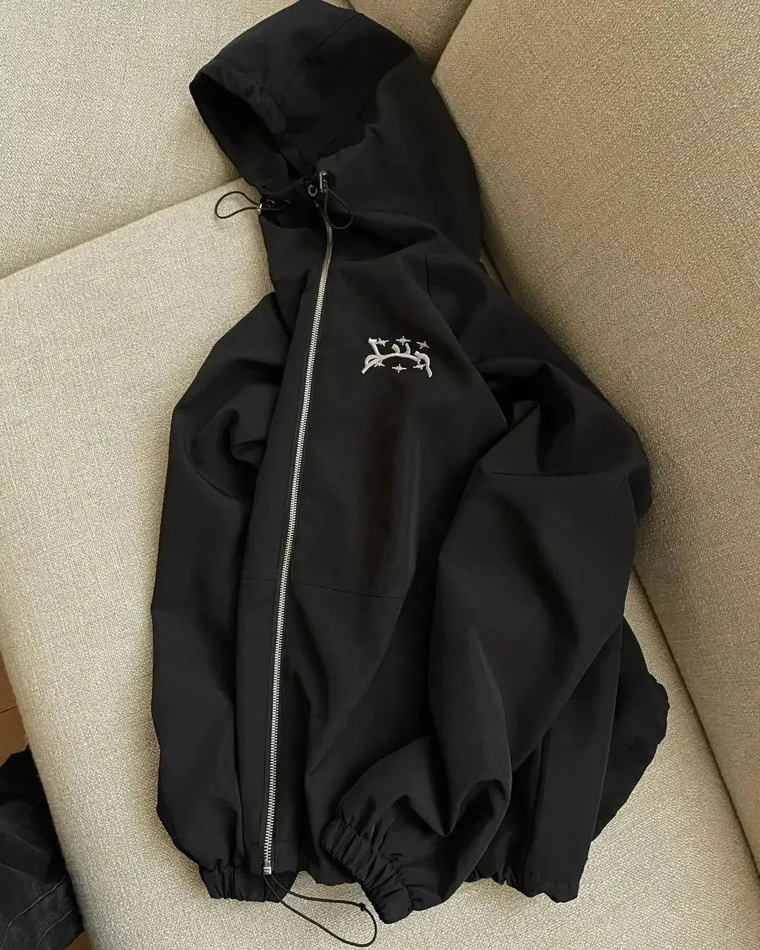 Men's loose fit hooded sunscreen jacket in polyester fabric shown in black colour with British style detailing