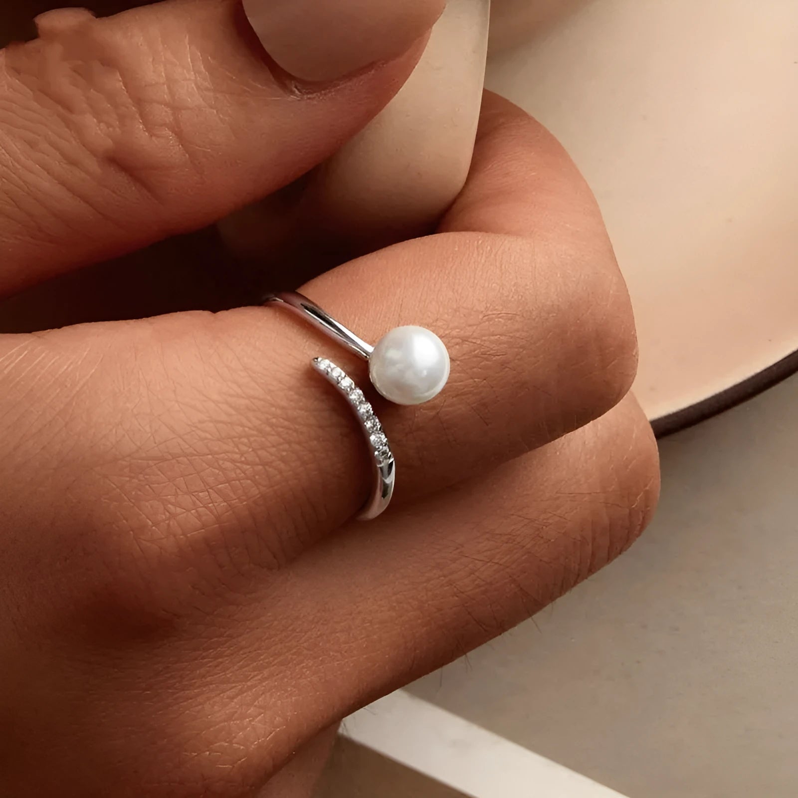 Sterling silver adjustable ring with shell pearls on open loop design