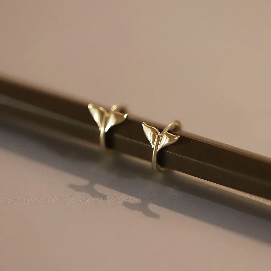 S925 sterling silver fishtail drop earrings in gold colour, showing smooth design and size.