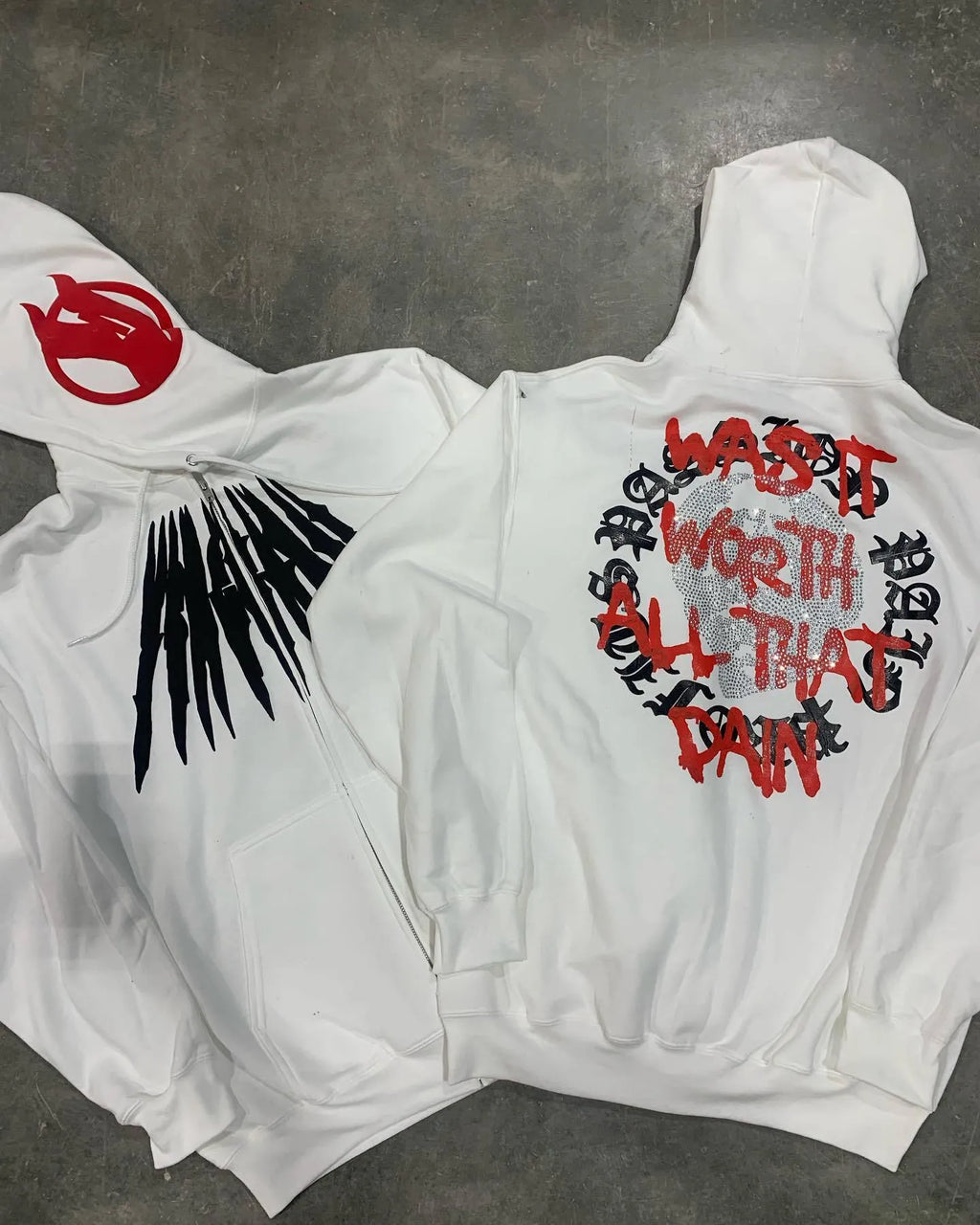 Black loose hooded sweatshirt with white printed skull and rhinestone detail, cardigan style.