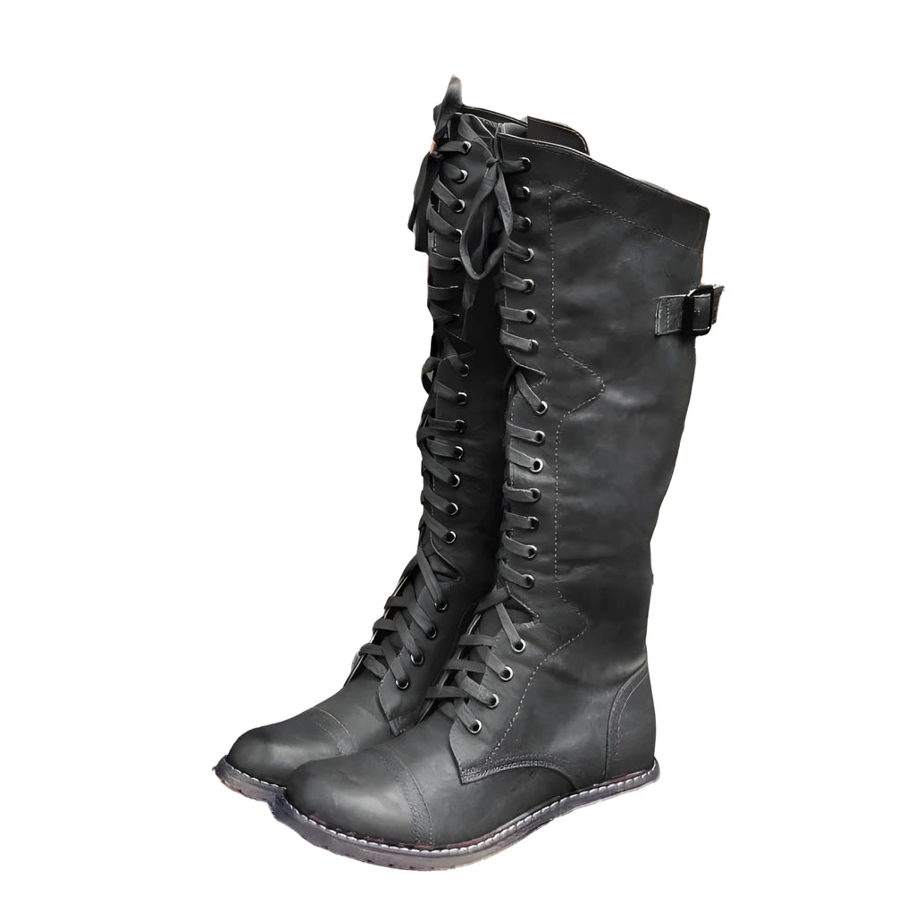 Women's black knight boots with cross-strap design across ankle in synthetic PU material