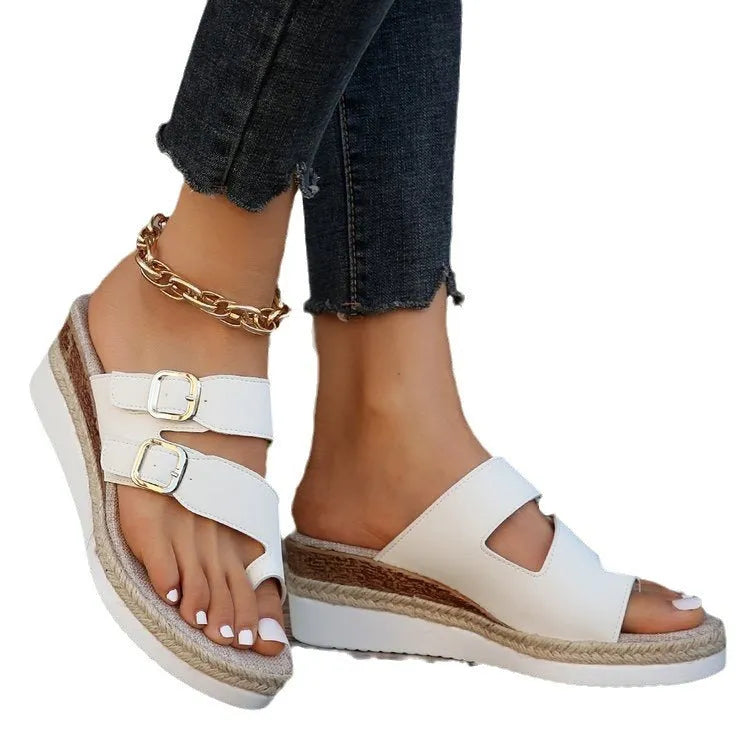 White woven patent leather wedge sandals with a peep toe and finger-fit strap design.