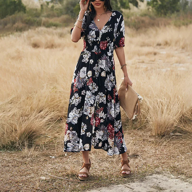 Women's yellow floral print summer dress with V neck and elastic waist on a mannequin.