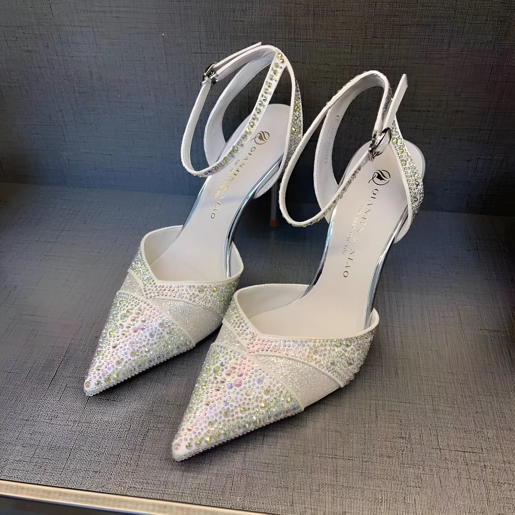 Women's black hollow stiletto heel pumps with a red sole and pointed toe.