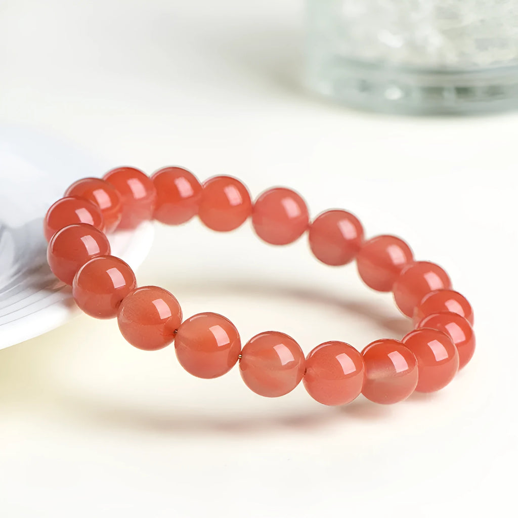 Natural South Red Cherry Agate bracelet showing polished beads in a single circle design.