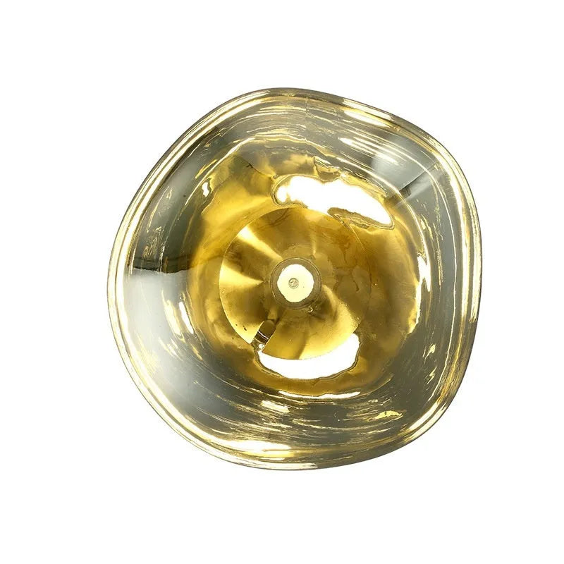 Modern creative lava wall lamp with acrylic shade, 30x18cm, gold finish, on a wall emitting warm light