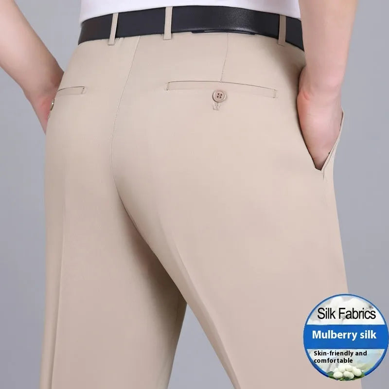 Man wearing dark blue non-iron straight-fit mulberry silk blend business trousers.
