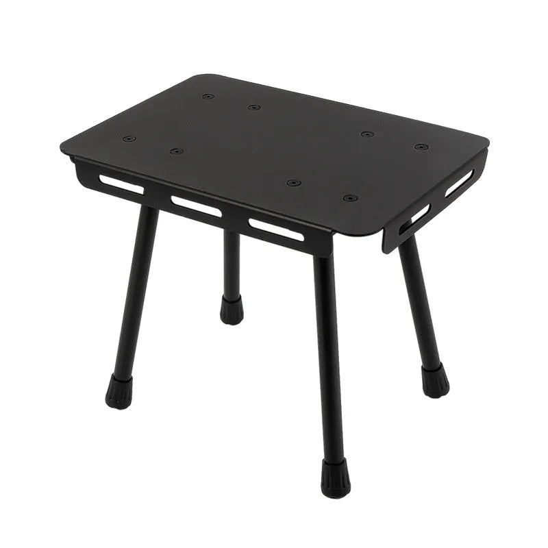 CLS aluminium folding camping stool shown in army green, converted into a small raised table next to a storage bag.