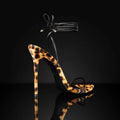 Women's leopard print Roman sandals with pointed toes and a buckle lace-up strap.