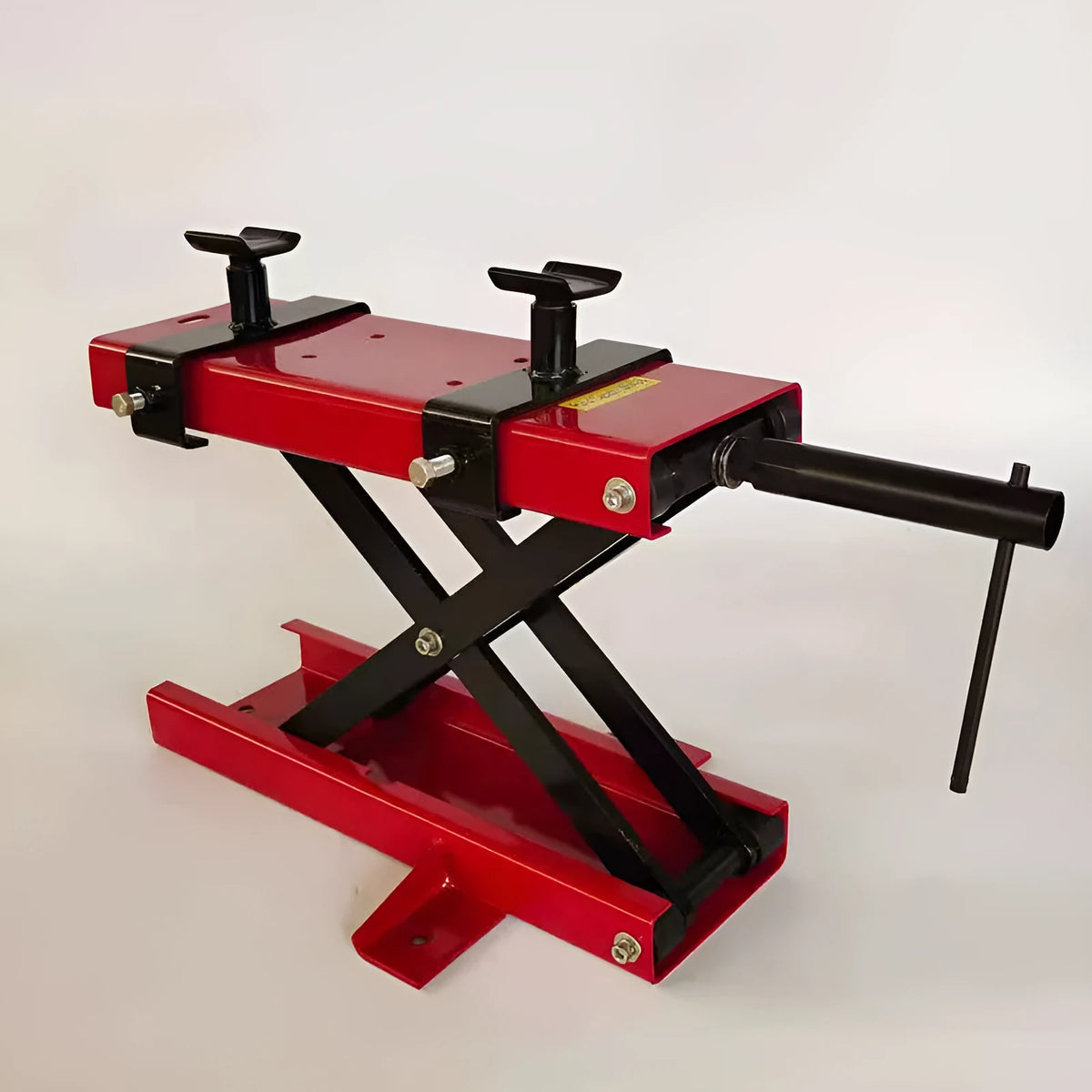 Red motorcycle support lift table raising a bike 16 inches above the ground for repair work