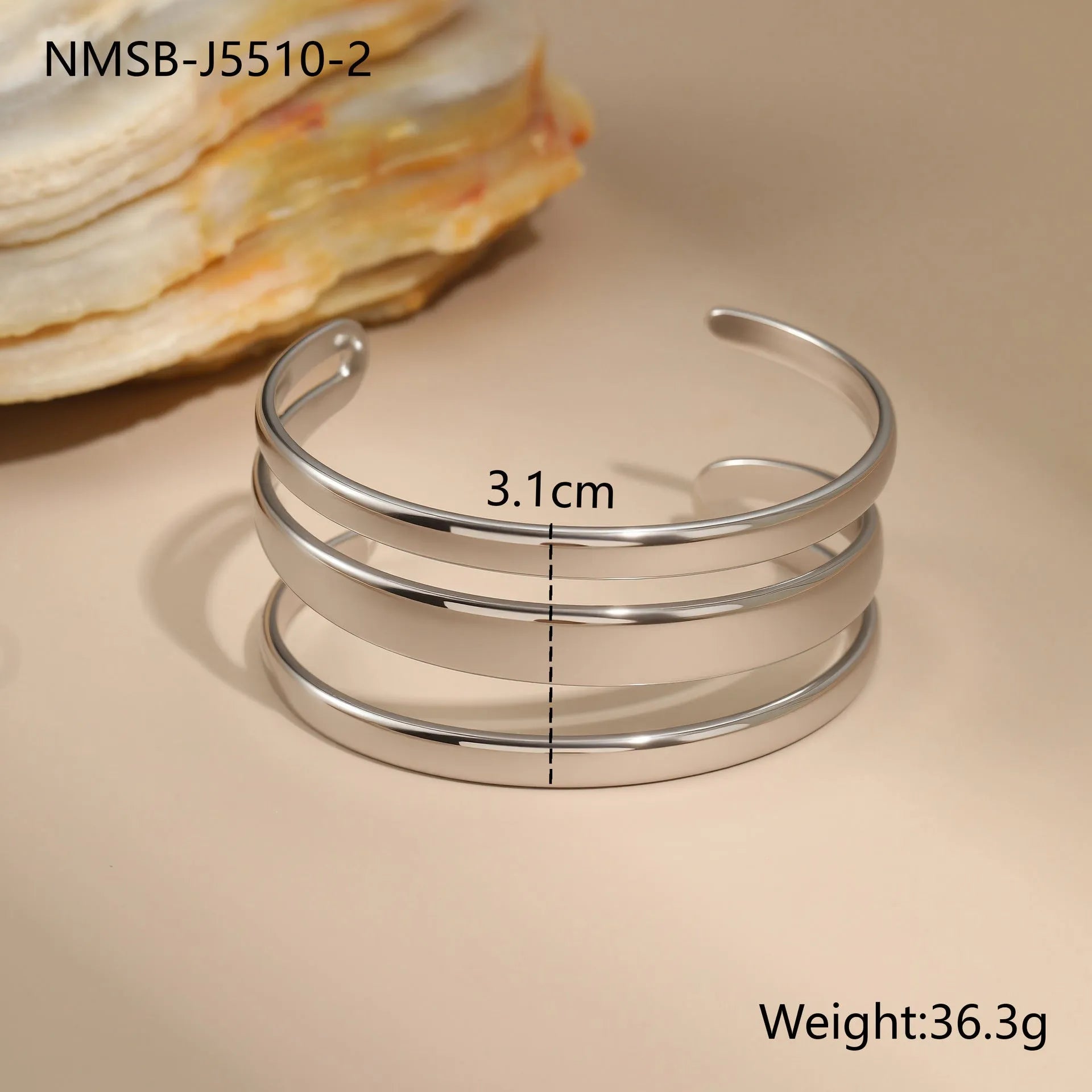 A geometric line design bracelet for women on wrist, shown in stainless steel with a simple opening clasp.