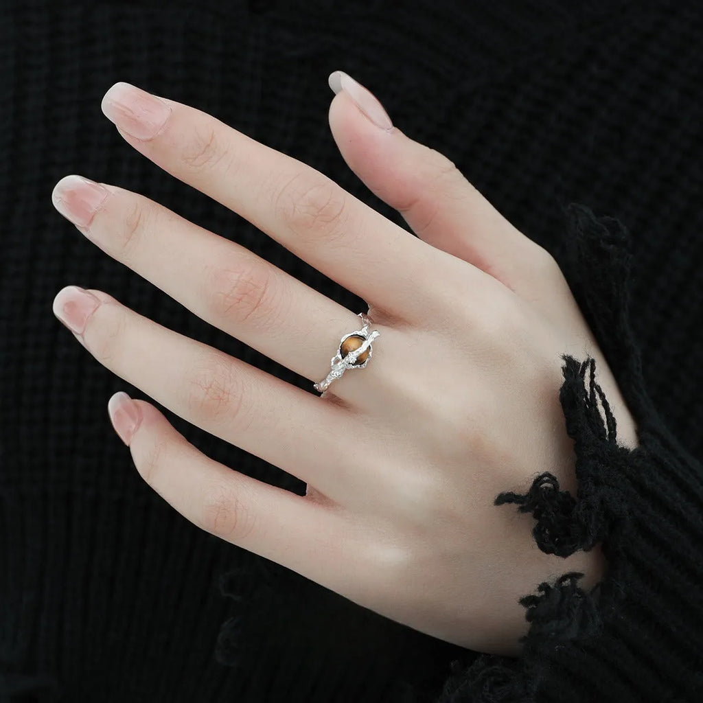 Women's adjustable Saturn design ring in silver with white gold electroplating.