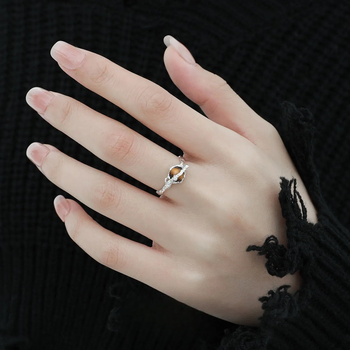 Women's adjustable Saturn design ring in silver with white gold electroplating.